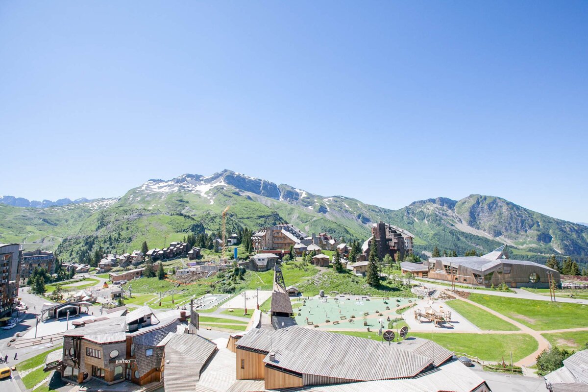 An aerial view of a ski resort with mountains in the background