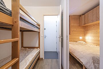 A bedroom with bunk beds and a single bed