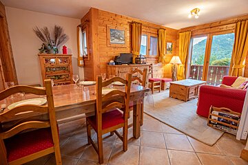 A living room with a dining table and chairs