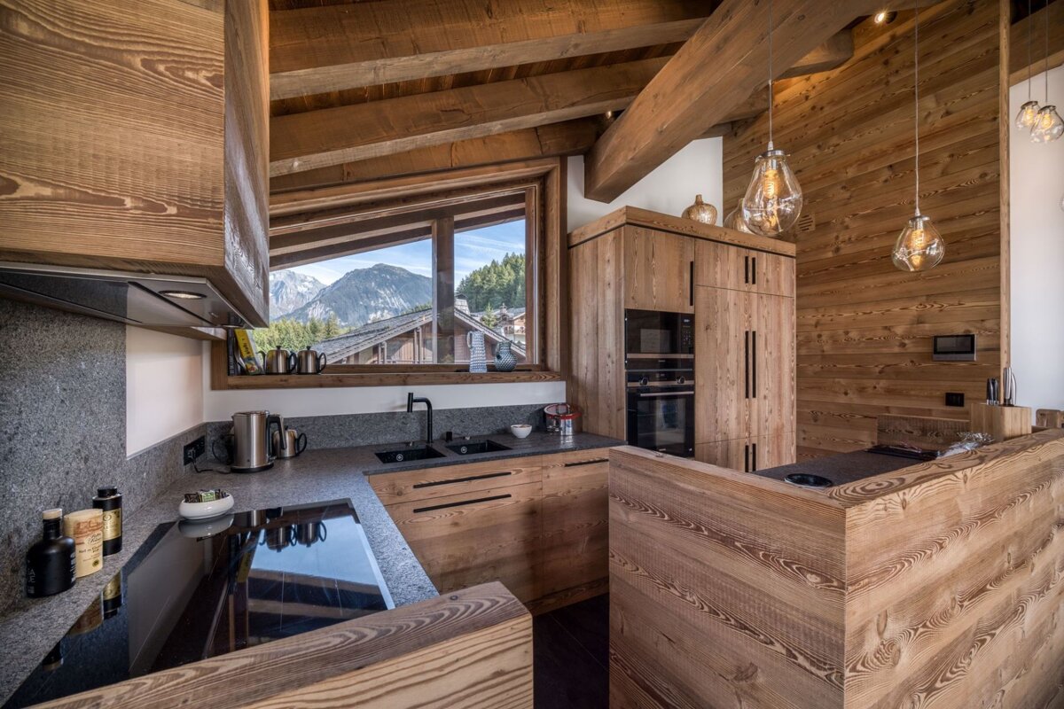 A kitchen with wooden cabinets and a stove top oven