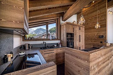 A kitchen with wooden cabinets and a stove top oven