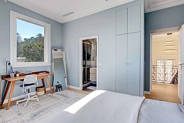 A bedroom with a desk and a mirror with a sticker that says ' i love you ' on it