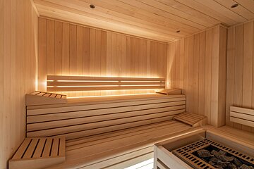 A bathroom with wooden walls and a bathtub