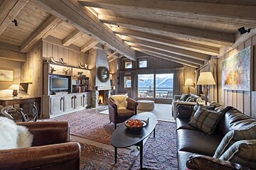 A living room with a couch and chairs and a fireplace