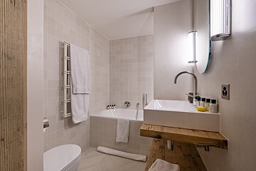 A bathroom with a sink a toilet and a bathtub