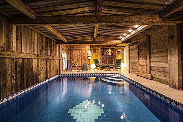 A large indoor swimming pool in a wooden building