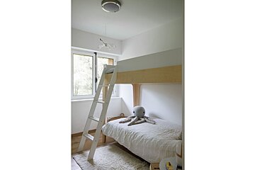 A bunk bed with a stuffed octopus on it