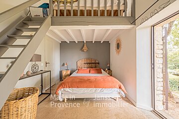 A bedroom with a bed made in provence by immobilier