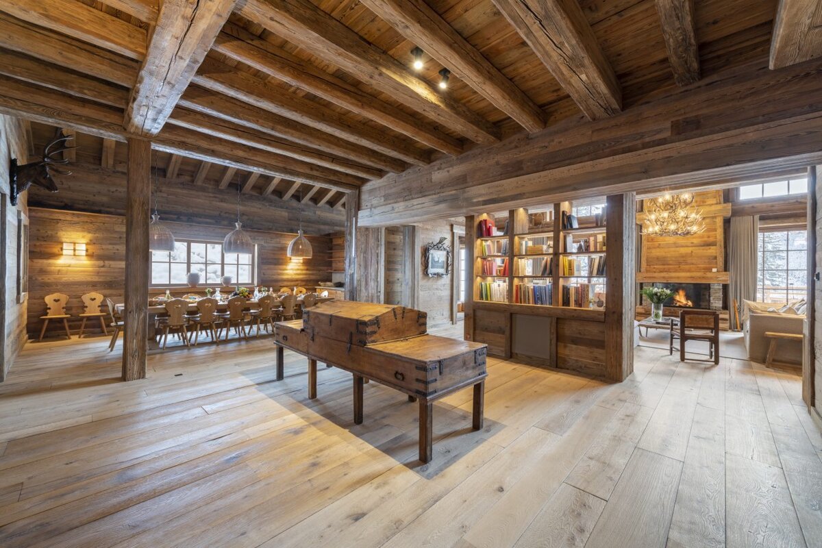 A large wooden room with a trunk on a table