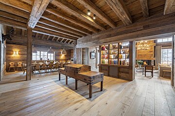 A large wooden room with a trunk on a table