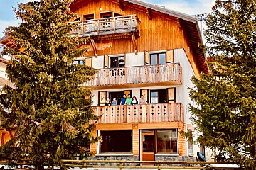A group of people standing on a balcony of a house
