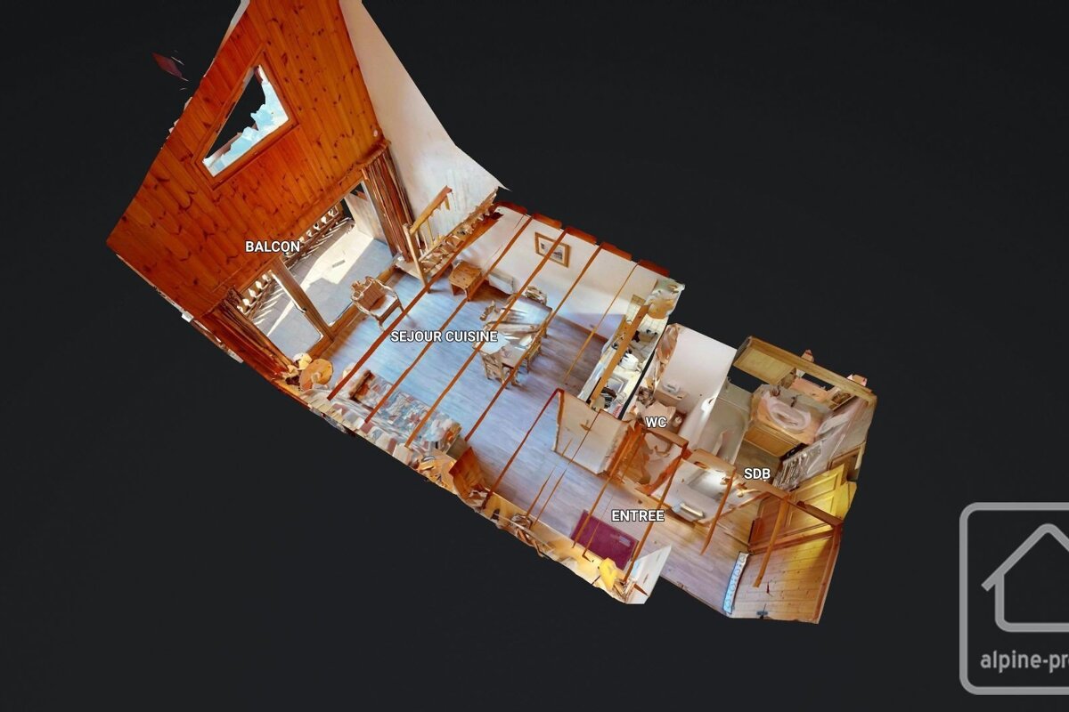 A 3D cutaway floor plan of a rustic-style home, showing labeled rooms like living/kitchen, balcony, entrance, WC, and bathroom.