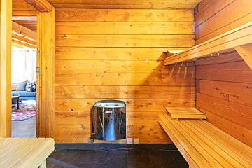 A sauna with a harvia heater on the wall