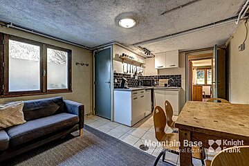 A living room with a couch and a table that says mountain base on it