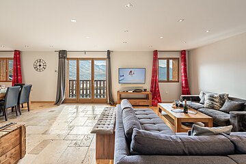 A living room with a couch and a flat screen tv
