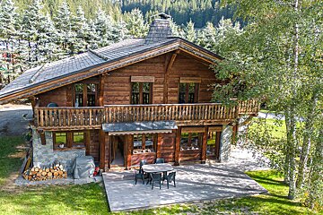 A wooden house with a roof that has shingles on it