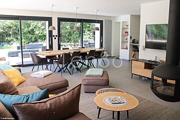A living room with a couch a table and a television with the word holidays in the corner