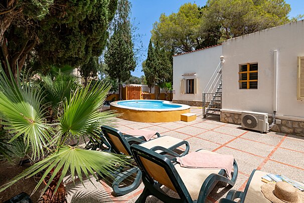 A white house with a swimming pool in the backyard