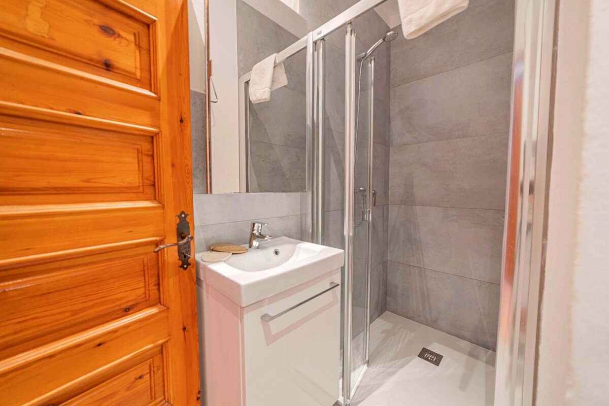 A bathroom with a sink and a walk in shower