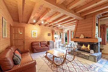 A living room with a couch and chairs and a fireplace