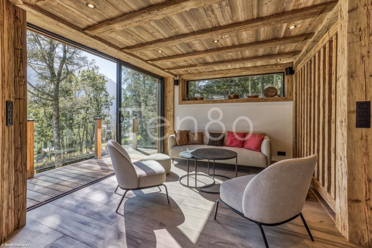 A living room with a couch and chairs and the number 80 on the wall