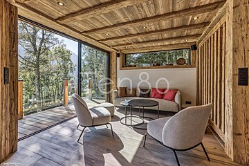 A living room with a couch and chairs and the number 80 on the wall