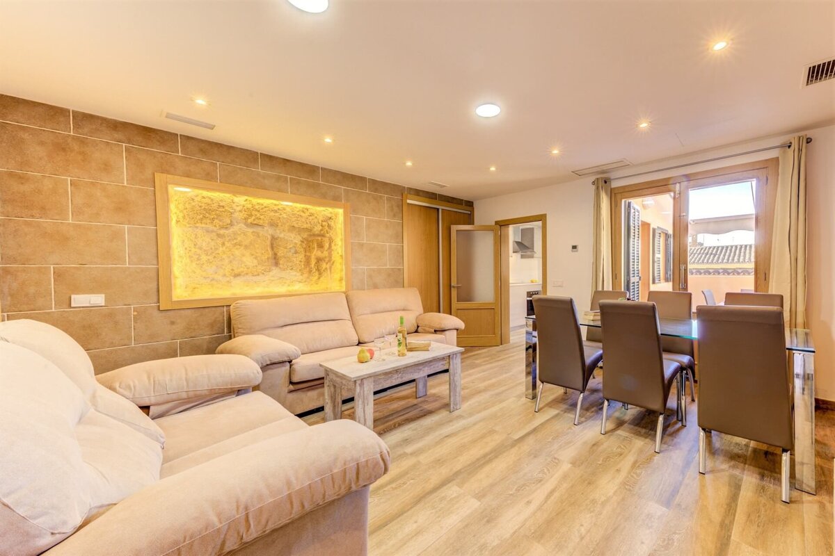 A living room with a couch and chairs and a table