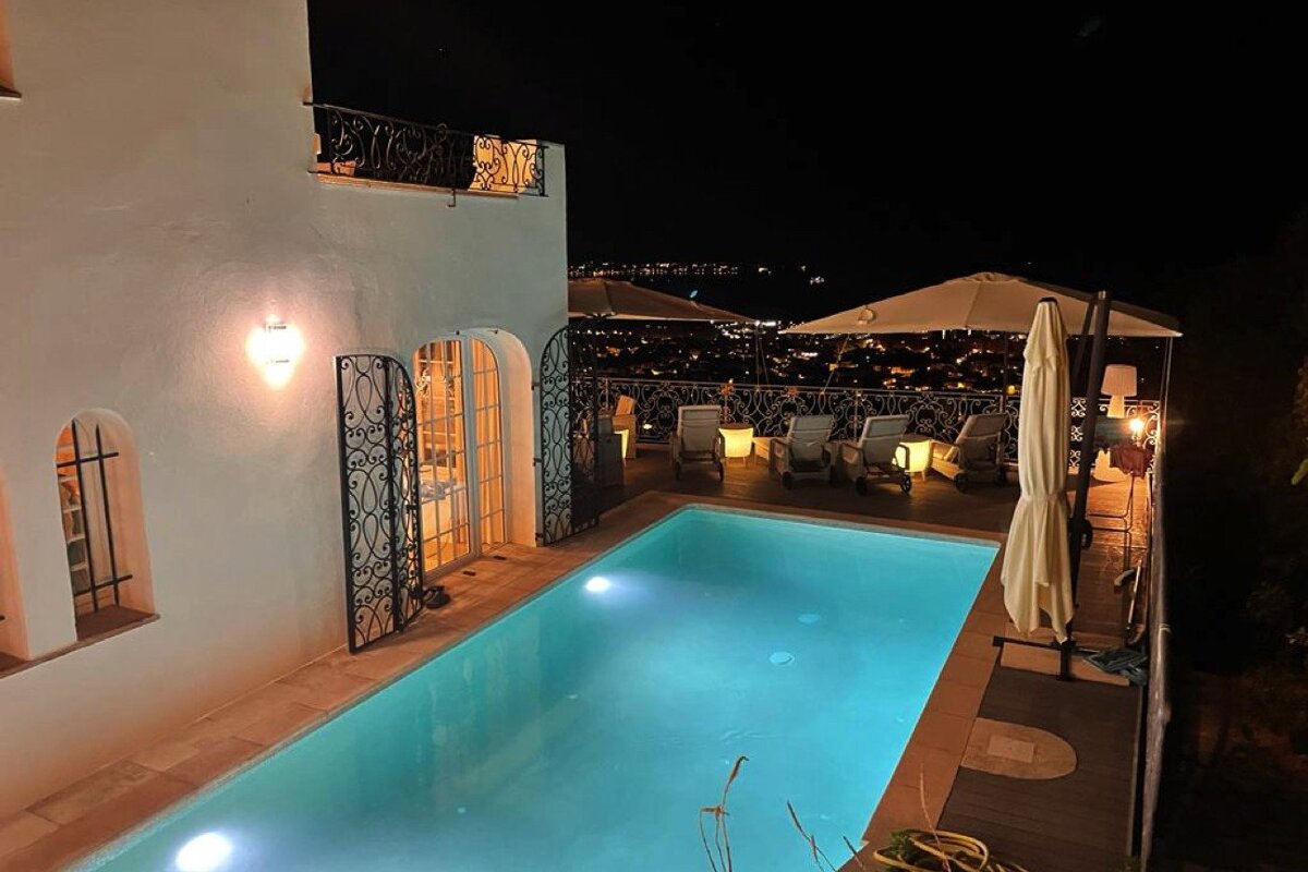 A large swimming pool is lit up at night