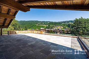 A balcony with a view of mountains and a sign that says mountain base