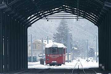 A red train with the number 53 on the front of it