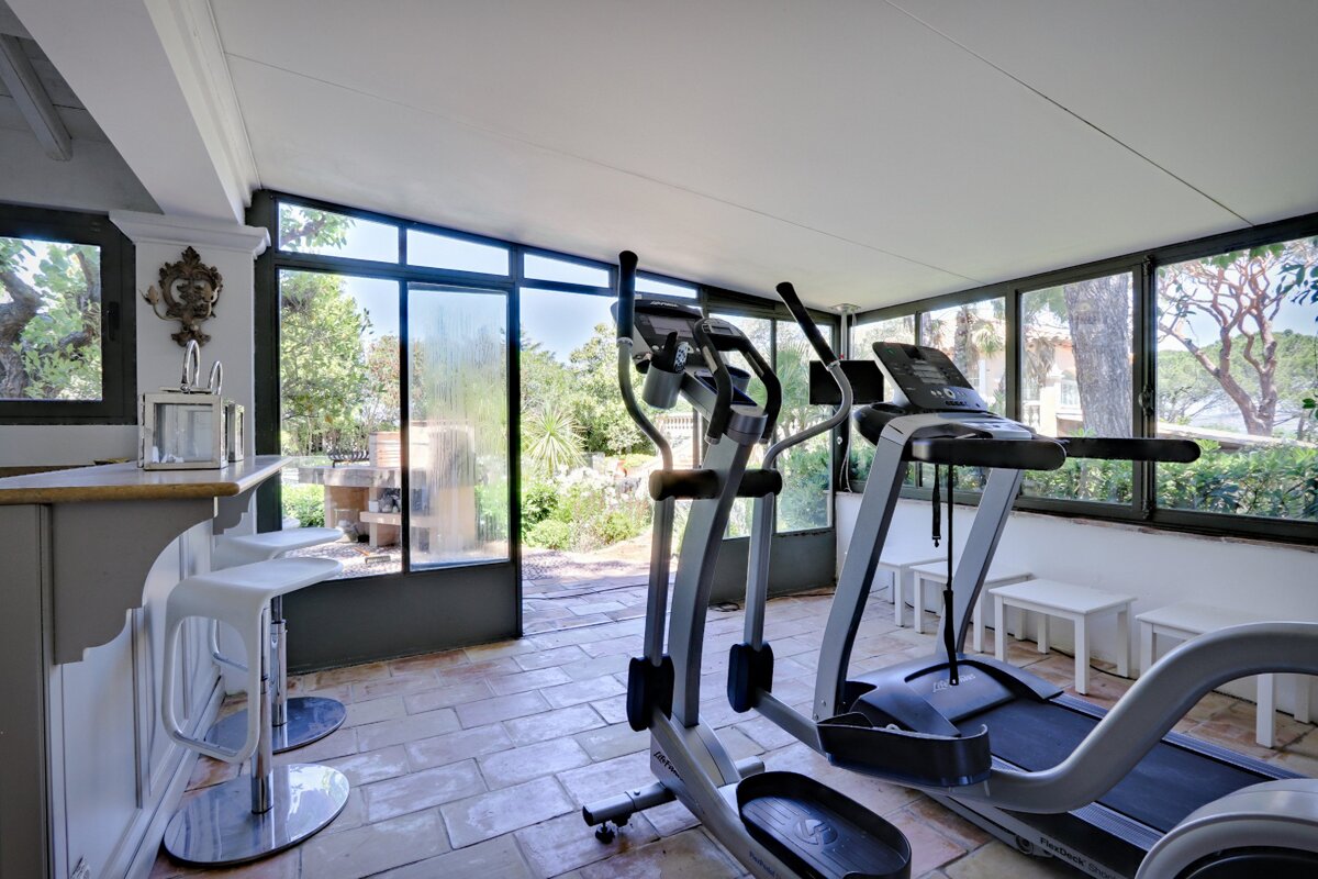 A gym with a treadmill and an elliptical
