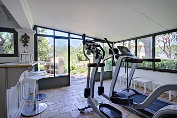 A gym with a treadmill and an elliptical