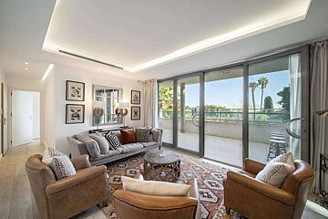 A living room with a couch and two chairs