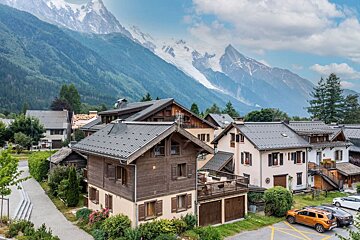 A row of houses with mountains in the background