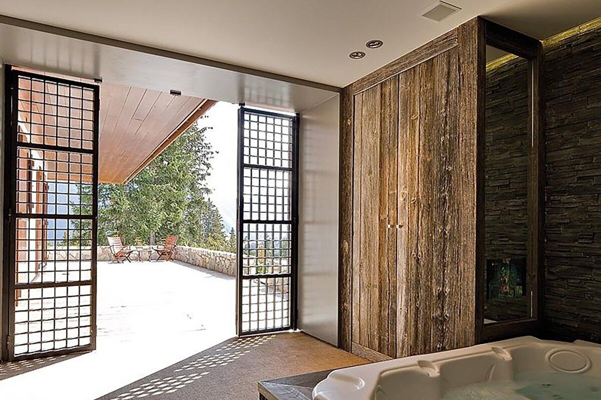 A bathroom with a jacuzzi and a view of a patio