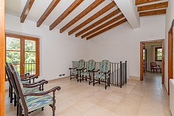 A row of chairs in a room with a wooden ceiling