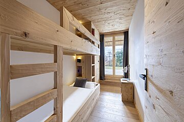 A bedroom with bunk beds and a window
