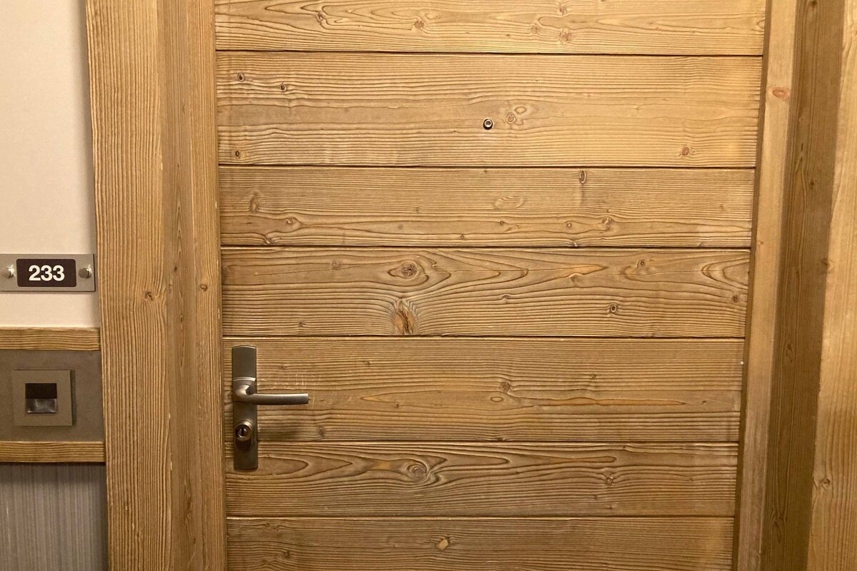 A wooden door with the number 233 on it