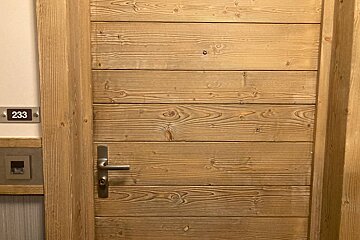 A wooden door with the number 233 on it