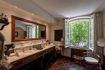 A bathroom with two sinks and a large mirror