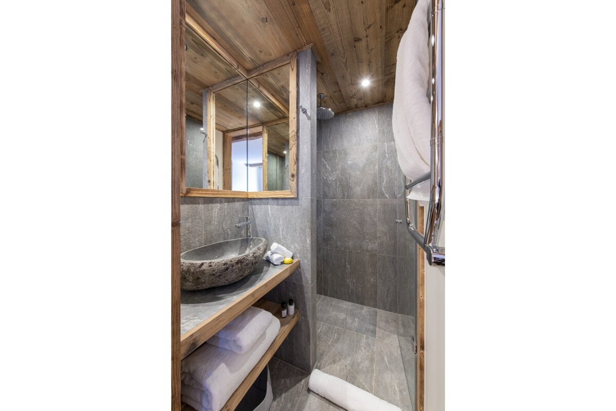 A bathroom with a sink and a walk in shower