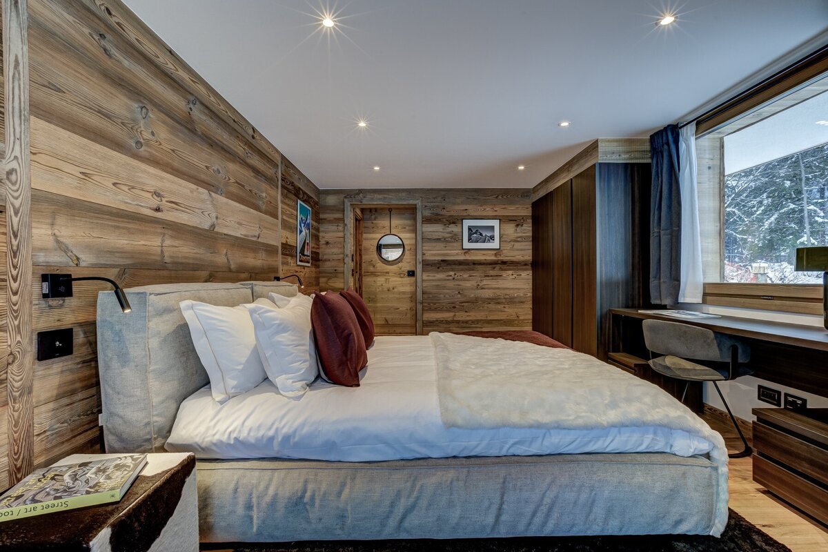 A bedroom with a king size bed and a book on a nightstand that says sonic art studio