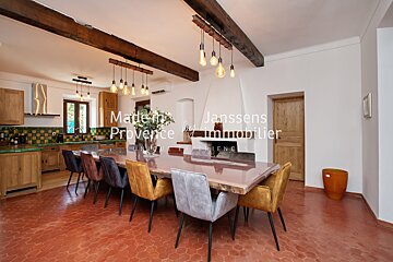 A kitchen and dining room with the words made in provence on the wall