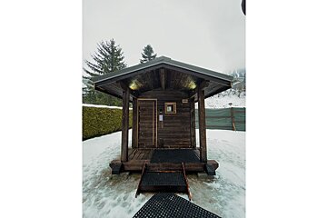 A small wooden house with stairs leading up to it
