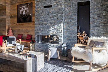 A living room with a fireplace and a picture of a bear on the wall