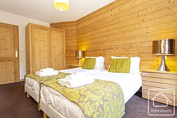 A bedroom with two beds and a sign that says alpine property