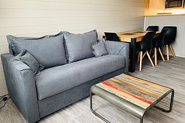 A living room with a couch a table and chairs