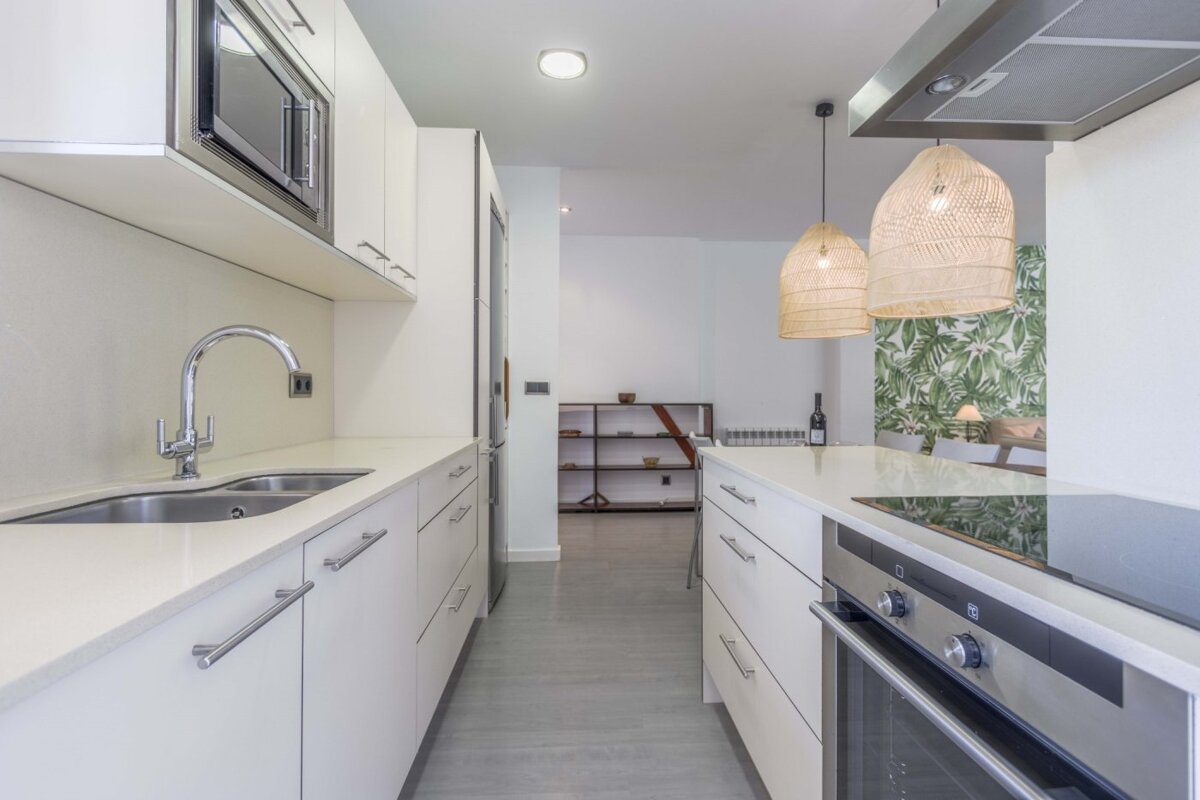 A kitchen with stainless steel appliances and white cabinets