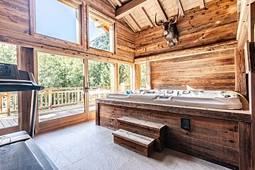 A wooden room with a backpack hanging from the ceiling