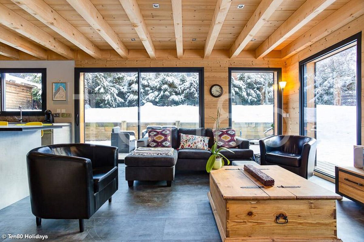 A living room with a wooden trunk on the floor